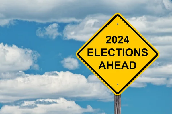2024 Elections Ahead Caution Sign Blue Sky Background Imagen de archivo