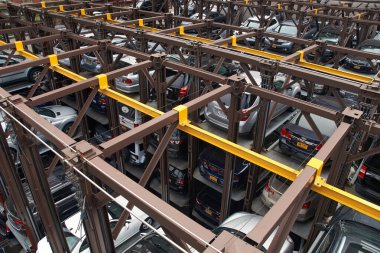 New York, NY, USA - October 14, 2017: An automated stacked mechanical car parking lot system, which uses hydraulic lifts to raise cars, leaving a roadway unobstructed. clipart