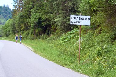 Slavsko road sign at the entrance to Slavske aka Slavsko, a rural settlement and a popular ski resort in the Skole Beskids range of the Carpathian mountains. Stryi Raion, Lviv Oblast, Ukraine. clipart