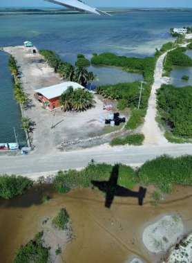 Shadow of airplane over earth. San Pedro, Ambergris Caye. Belize
