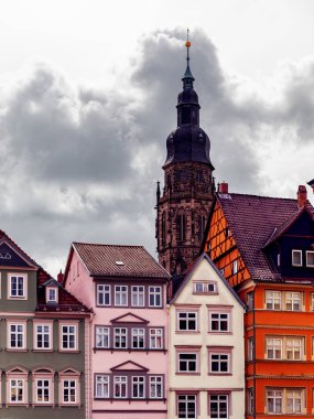 View of traditional German timber-framed houses on Marktplatz Coburg with historic St. Moriz Church rising in background. Classic mix of civic and sacred architecture in Bavarian old town