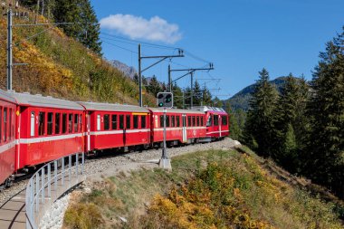 bernina express mountain railway train climbing above san carlo