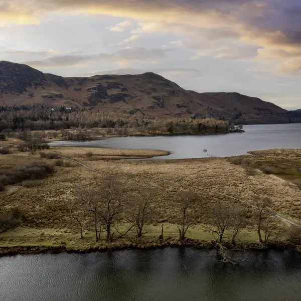 stock image great bay and the river derwent at the south end of derwent water looking towards catbells and maiden moor aerial view simulated sunset