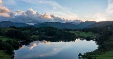 panoramic aerial view of loughrigg tarn near skelwith bridge lake district at sunset with the langdale pikes beyond no people clipart