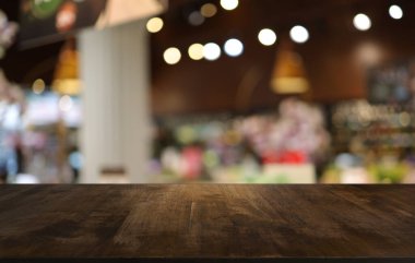 Wood table top in front of abstract blurred background. Empty wooden table space for text marketing promotion. blank wood table surface copy space for background.
