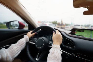 Woman driving car. girl feeling happy to drive holding steering wheel and looking on roa