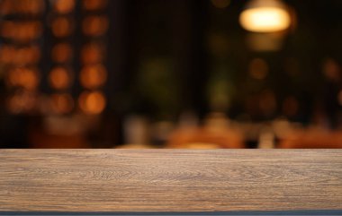 Wood table top in front of abstract blurred background. Empty wooden table space for text marketing promotion. blank wood table surface copy space for background.