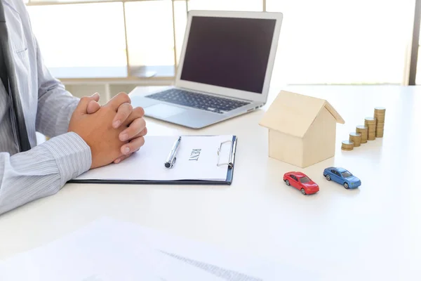 stock image Sales manager giving advice application form document, considering mortgage loan offer for car and house insurance