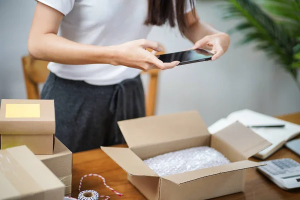 stock image Business From Home Asian woman preparing package delivery box Shipping for shopping online. young start up small business owner at home online order.