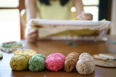 Punch needle. Asian Woman making handmade Hobby knitting in studio workshop. designer workplace Handmade craft project DIY embroidery concept