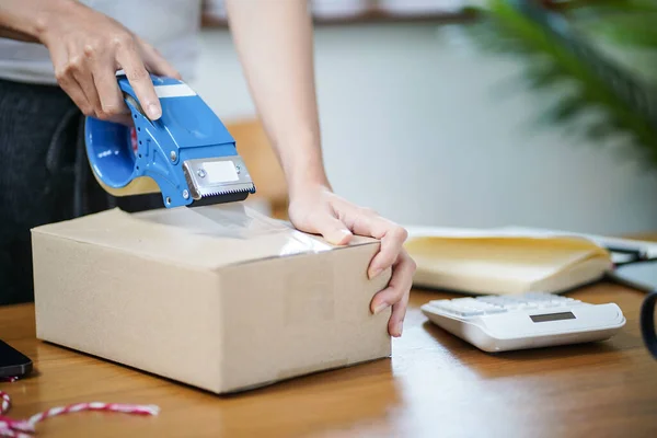 stock image Business From Home Asian woman preparing package delivery box Shipping for shopping online. young start up small business owner at home online order.
