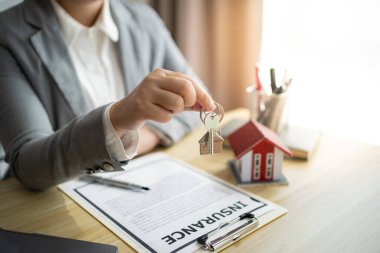 Sales manager giving advice application form document, considering mortgage loan offer for car and house insurance. Real estate investment Property insurance and security. Real estate agent offer house
