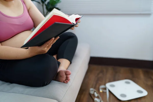 Overweight woman reading book for lose weight. Fat woman worried about weight diet Lose weight lifestyle.
