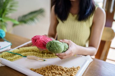 Punch needle. Asian Woman making handmade Hobby knitting in studio workshop. designer workplace Handmade craft project DIY embroidery concept