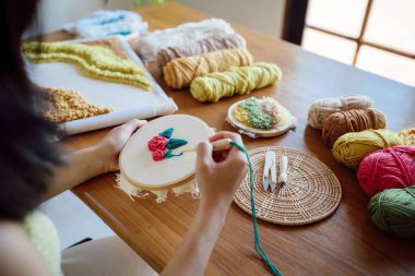 Punch needle. Asian Woman making handmade Hobby knitting in studio workshop. designer workplace Handmade craft project DIY embroidery concept