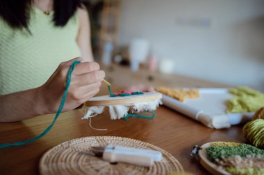 Punch needle. Asian Woman making handmade Hobby knitting in studio workshop. designer workplace Handmade craft project DIY embroidery concept