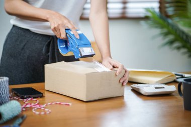 Asian woman preparing package delivery box Shipping for shopping online delivery mail service people and shipment concept.
