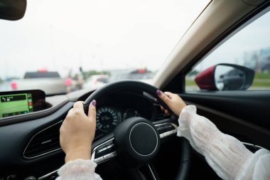 Woman driving car. girl feeling happy to drive holding steering wheel and looking on roa