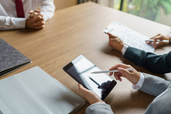Examiner reading a resume during job interview at office Business and human resources concept.