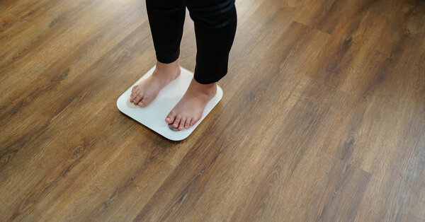 over weight woman on scale