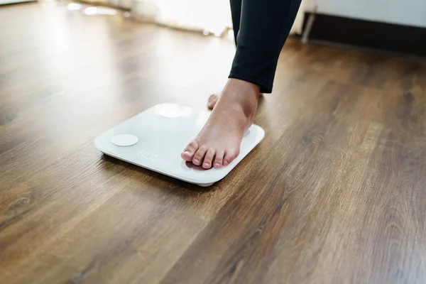 stock image Obese Woman with fat upset bored of dieting Weight loss fail Fat diet and scale sad asian woman on weight scale at home weight control