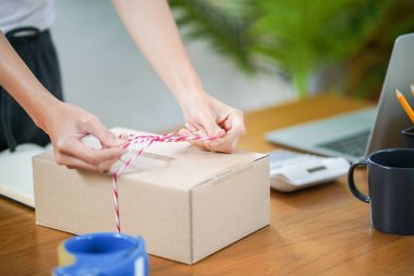 Asian woman preparing package delivery box Shipping for shopping online delivery mail service people and shipment concept.