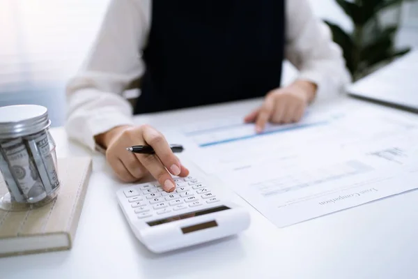 stock image Businesswoman Accountant analyzing investment charts Invoice and pressing calculator buttons over documents. Accounting Bookkeeper Clerk Bank Advisor And Auditor Concept.