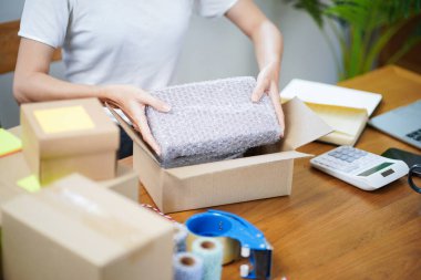 Asian woman preparing package delivery box Shipping for shopping online delivery mail service people and shipment concept.
