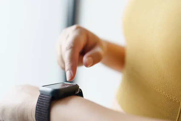 stock image Woman workout with health app on smart watch Close-up hands.