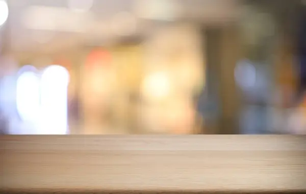 stock image Empty wooden table in front of abstract blurred background of coffee shop . wood table in front can be used for display or montage your products.Mock up for display of produc