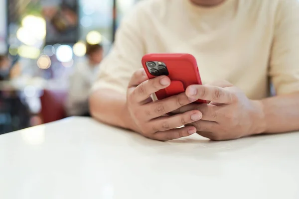 stock image Relaxed young asian man using smart phone  spending time checking news social media