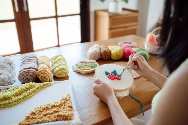 Punch needle. Asian Woman making handmade Hobby knitting in studio workshop. designer workplace Handmade craft project DIY embroidery concept