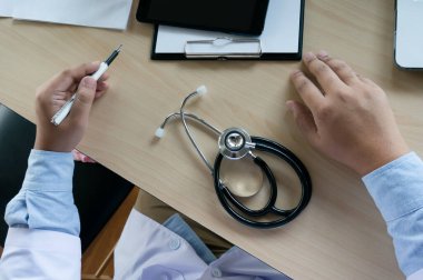 Doctor healthcare. Professional medical doctor in white uniform gown coat interview consulting patient reassuring his male patient helping hand.