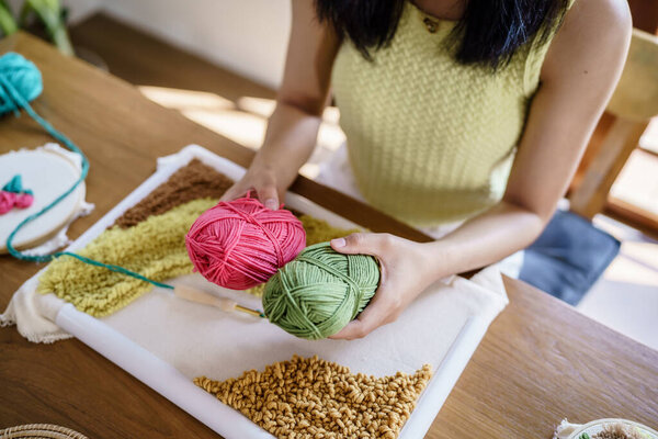 Punch needle. Asian Woman making handmade Hobby knitting in studio workshop. designer workplace Handmade craft project DIY embroidery concept