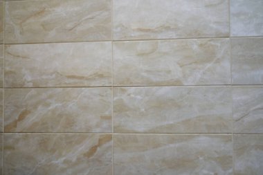 İnce bej bir fayans dokusu. Küçük ışık dalgaları arka plana sığması için düzenlenir. Kopyalanacak yeri olan bej fayanslar. Yüksek kalite fotoğraf