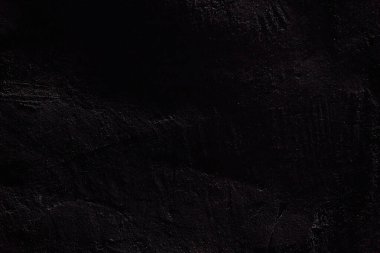 Siyah taş yüzeyin dokusu. Kopyalamak için yeri olan pürüzlü, pürüzlü duvar. Yüksek kalite fotoğraf