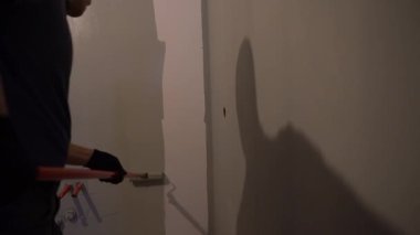 Ev tadilatı, yenileme konsepti. İç tasarım için inşaat malzemeleri. Oda dekorasyonu, daire. Elle boyanmış duvarlar ve gri bir boya silindiri. Yüksek kalite 4k görüntü