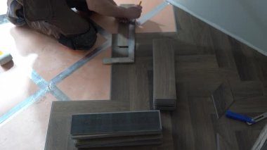 Dairenin tadilatı. Ringa kemiği şeklinde kuvars vinil döşeme. Laminat veya kuvars vinil kaplama koyu renk ve ahşap desenli. Yüksek kalite 4k görüntü