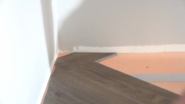 Dairenin tadilatı. Ringa kemiği şeklinde kuvars vinil döşeme. Laminat veya kuvars vinil kaplama koyu renk ve ahşap desenli. Yüksek kalite 4k görüntü