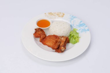 Fried chicken with rice and sweet sauce in a dish on an isolate background.