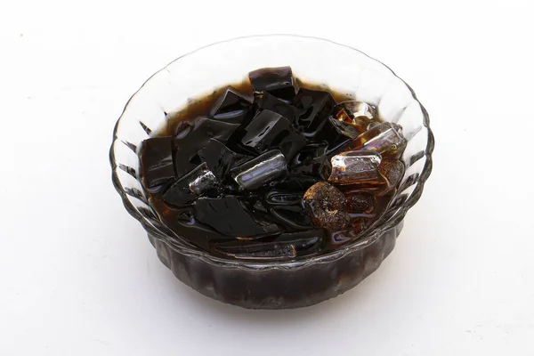 stock image black grass jelly and syrup and ice in a bowl on white background.