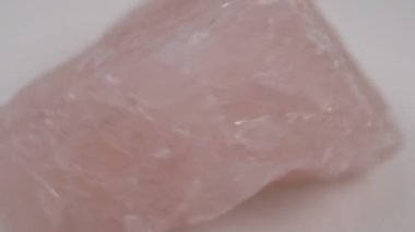 Natural mineral crystal of rose quartz gemstone. Natural rose quartz crystal. White background