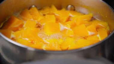 Cooking pumpkin in water, pumpkin soup. Selective focus. Diet soup in a pot.