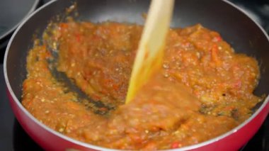 Grilled red peppers ajvar, a traditional serbian dish. Selective focus. Mashed and cooked peppers at home in the kitchen