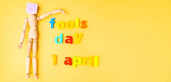 Yellow Background Wooden Doll Smile Fools Day April Copy Space — Stock Photo, Image