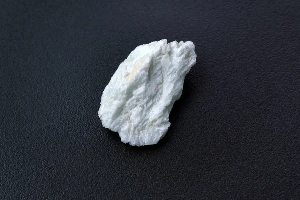 Albite crystal mineral, black background close up. Lepidolite