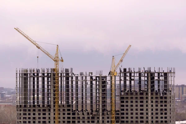 Construction cranes, construction site. Housing construction, apartment block in city. Copy Space. Selective focus