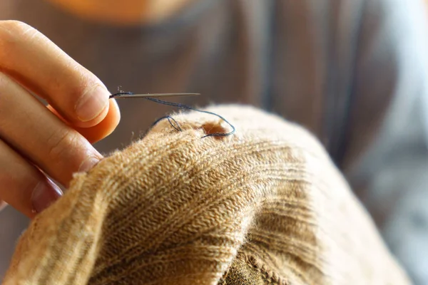 Stock image Mending clothes. Sewing supplies and old clothes for repair. Needlework, recycling and thrift. Selective focus