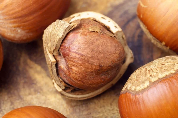 stock image Hazelnut on wooden table. Heap or stack of hazelnuts. Close up macro