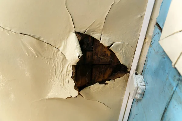 stock image Old ceiling in a wooden house, damaged a huge hole in the roof from rainwater leakage.